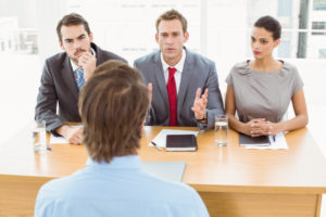 business-people-interviewing-man-in-office_