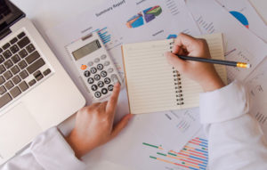 top-view-business-woman-hand-using-calculator-and-laptop_