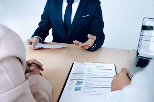 Business-situation-job-interview-concept-Job-seeker-present-resume-to-managers
